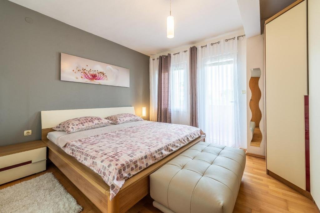 Main bedroom with a double bed, wardrobe and bright window